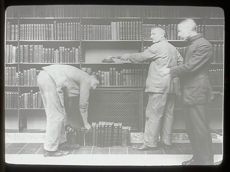 Three men dusting books. New York Public Libray