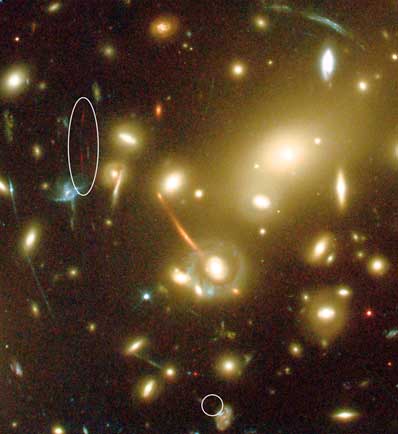 A new galaxy (split into two 'images' marked with an ellipse and a circle) was detected in this image taken with the Advanced Camera for Surveys onboard the NASA/ESA Hubble Space Telescope. The extremely faint galaxy is so far away that its visible light has been stretched into infrared wavelengths, making the observations particularly difficult. Credit: European Space Agency, NASA, J.-P. Kneib (Observatoire Midi-Pyrenees) and R. Ellis (Caltech).