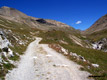 A long dirt road climbs inside the Torta valley