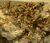 Calcopirite in cristalli di 3 mm su calcite. Miniera Pozzarelli, Fontana Inversa (Allumiere)
